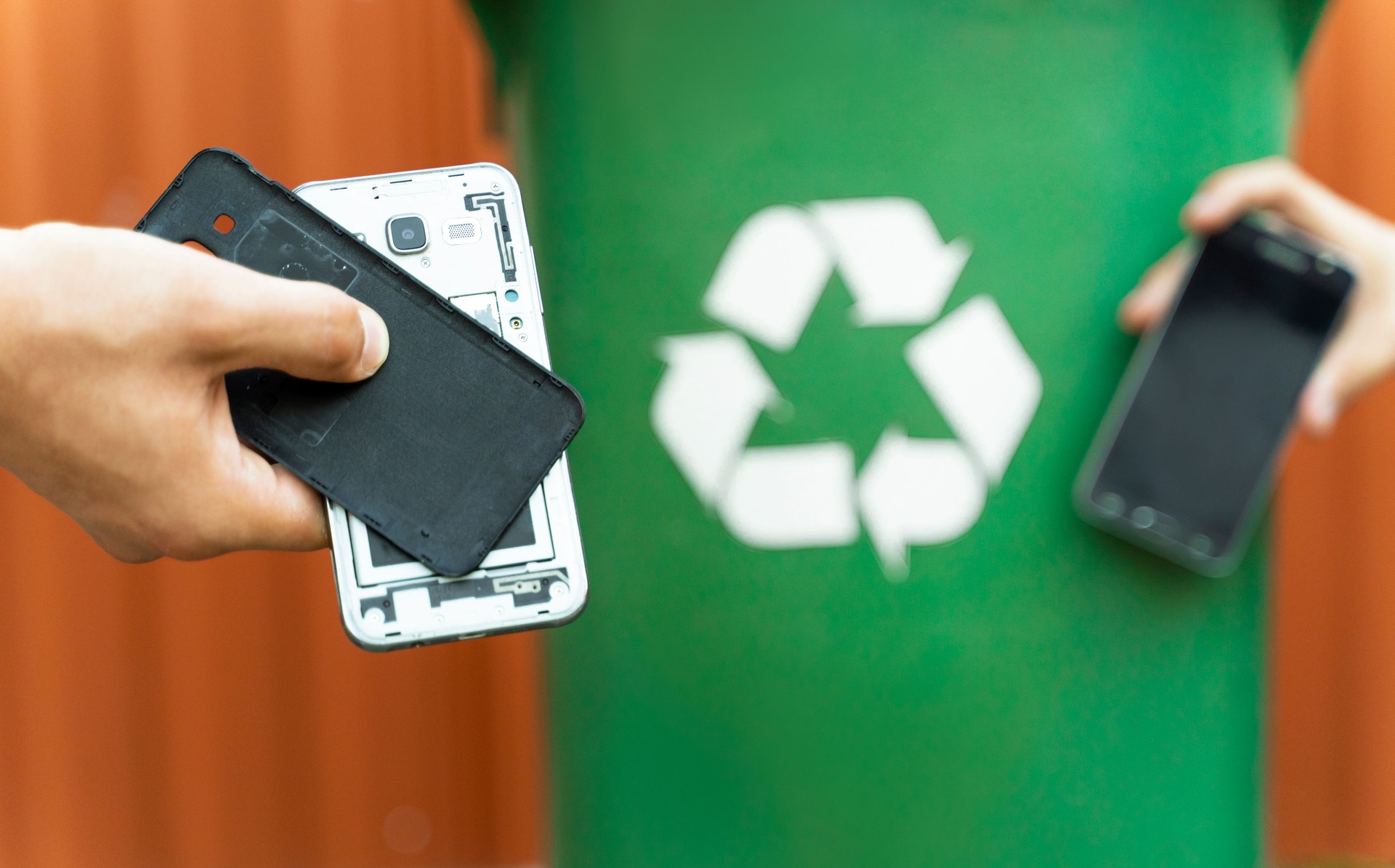 E waste ,disassembled smartphone and recycle bin